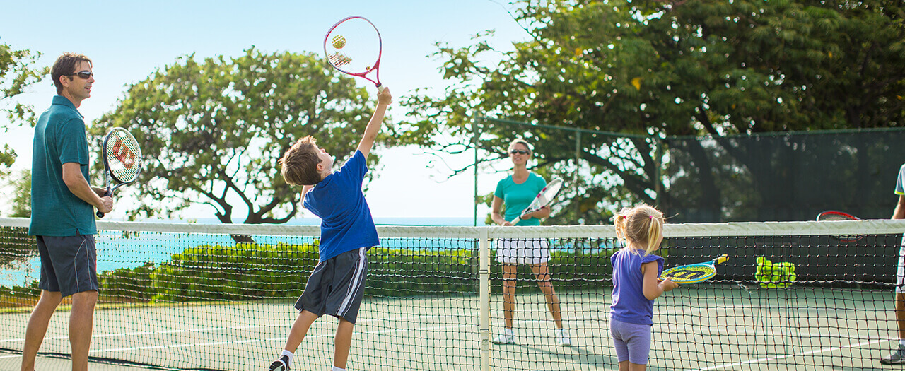 Family playing tennis