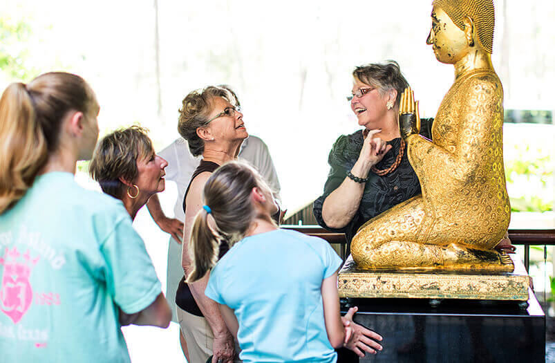 docent speaking about buddha statue