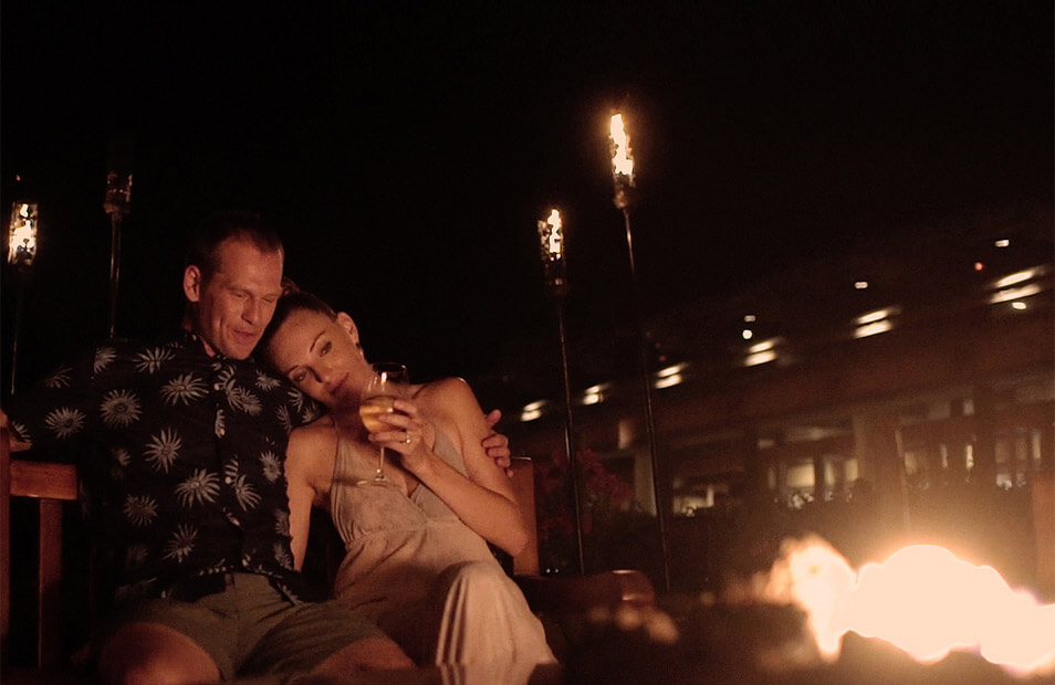 couple relaxing in front of fire